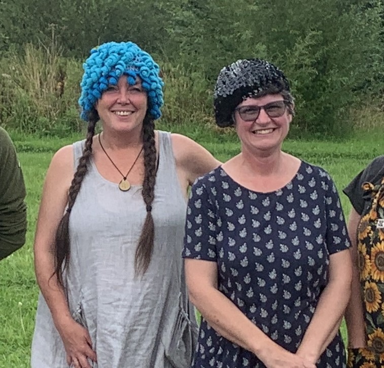 two women in the outdoors wearing hats